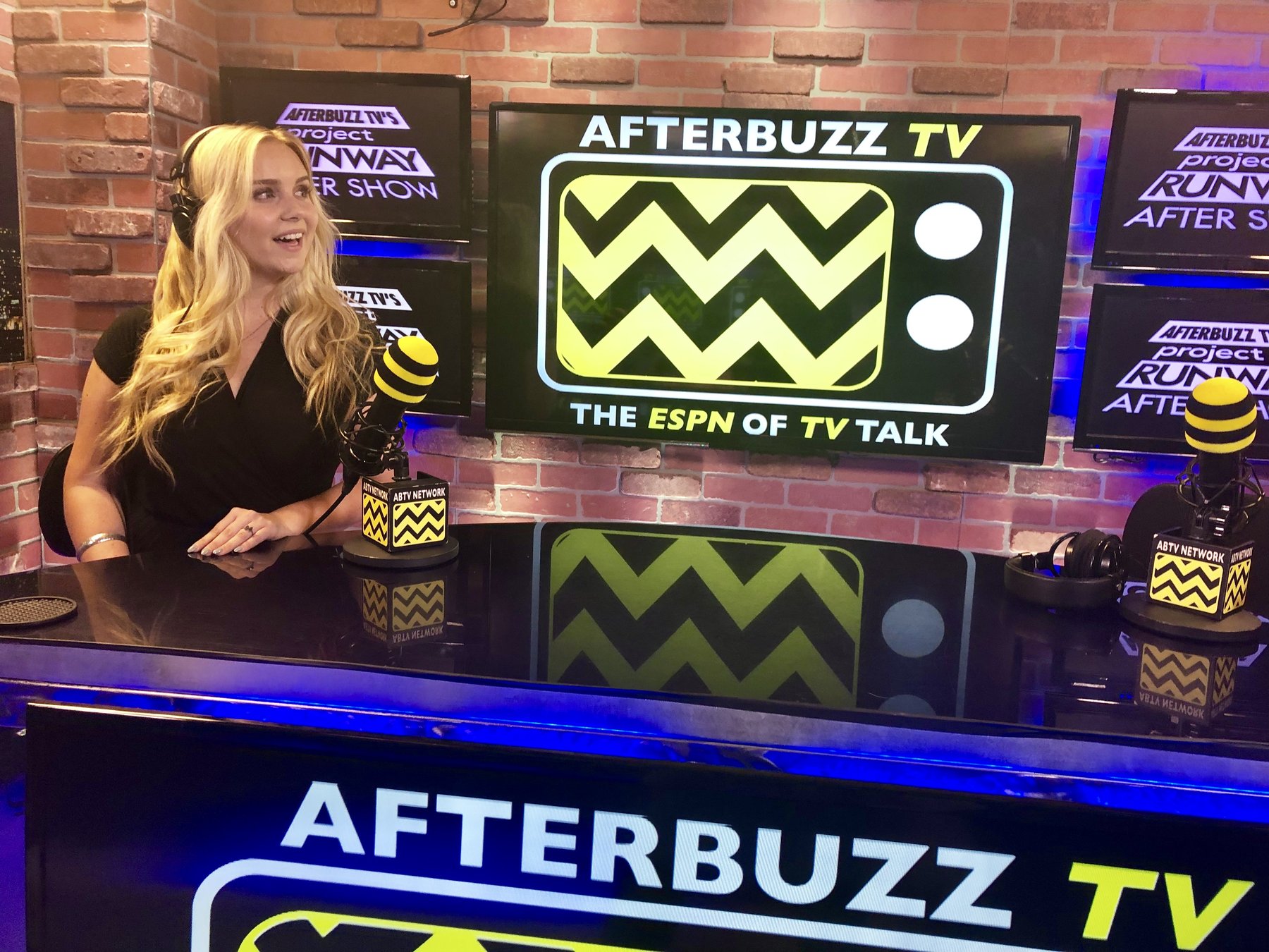 Jessica O'Connor hosting on the AfterBuzz TV set with "The ESPN of TV Talk" backdrop