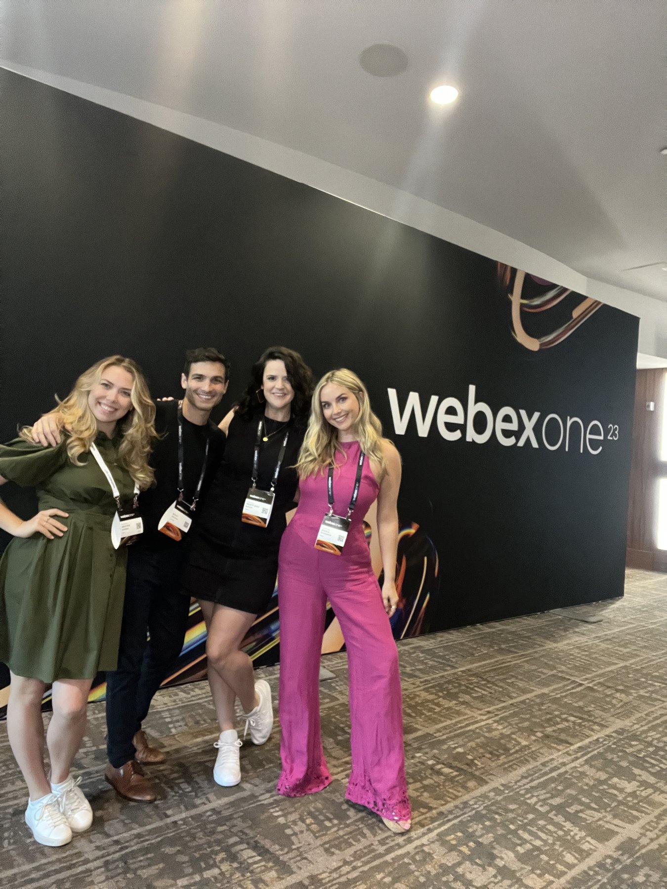 Jessica O'Connor with the WebexOne 2023 team in front of the event backdrop